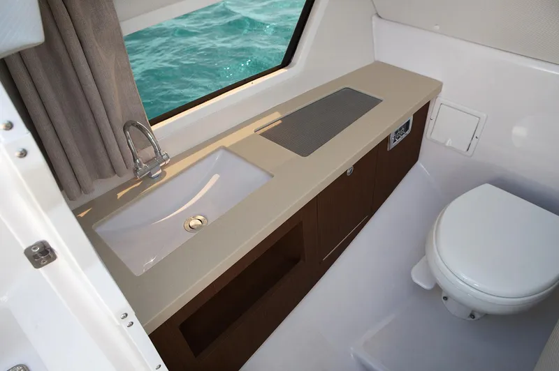  Yacht Photos Pics Manufacturer Provided Image: 2019 Four Winns Horizon H290 boat bathroom with sink, toilet, and window.