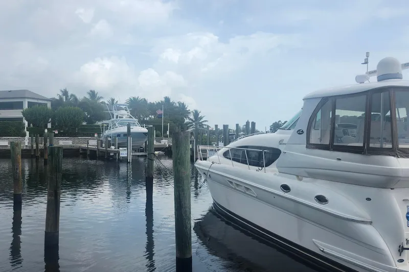  Yacht Photos Pics 2004 Sea Ray 480 Motor Yacht docked at a marina with palm trees in the background.