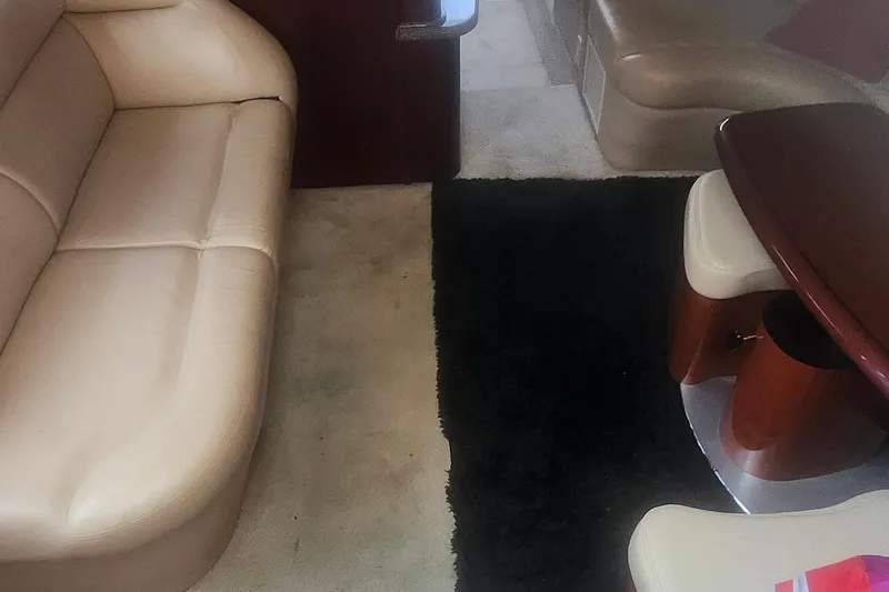  Yacht Photos Pics Interior of 2004 Sea Ray 480 Motor Yacht with beige seating and dark rug.