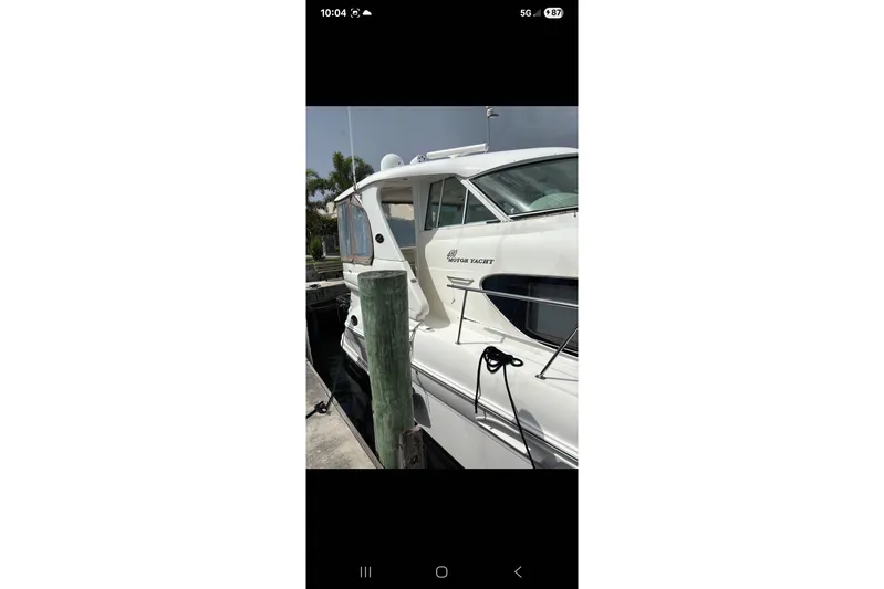  Yacht Photos Pics 2004 Sea Ray 480 Motor Yacht docked at marina, side view.