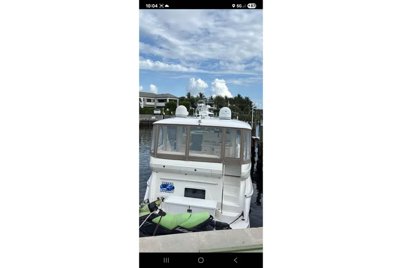  Yacht Photos Pics 2004 Sea Ray 480 Motor Yacht docked at marina under a partly cloudy sky.