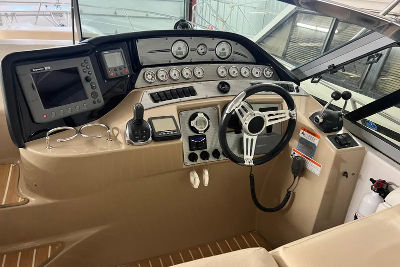 Belle Journee Yacht Photos Pics 2008 Four Winns V378 boat helm with steering wheel, gauges, and navigation equipment.