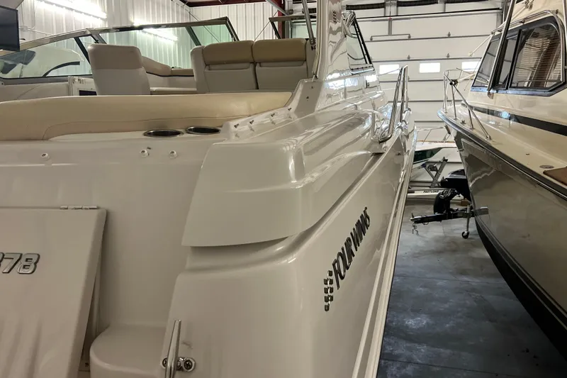 Belle Journee Yacht Photos Pics 2008 Four Winns V378 boat in storage, showcasing sleek design and white exterior.