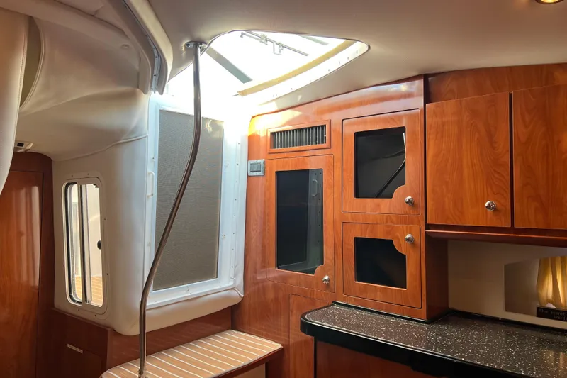 Belle Journee Yacht Photos Pics Interior of 2008 Four Winns V378 yacht with wood cabinetry and skylight.