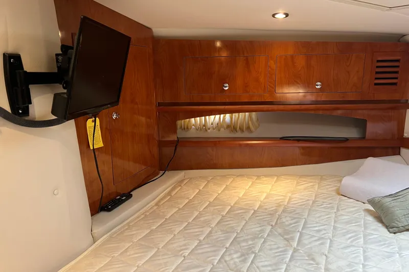 Belle Journee Yacht Photos Pics Interior cabin of 2008 Four Winns V378 with wood paneling and mounted TV.