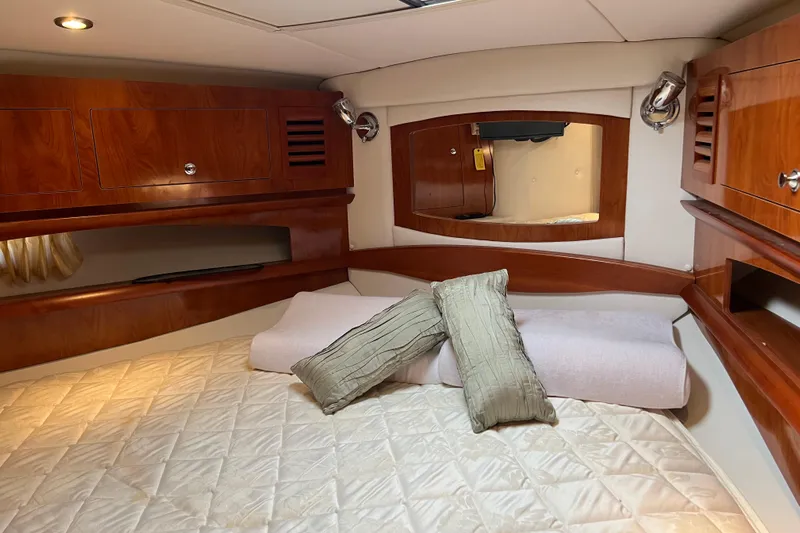Belle Journee Yacht Photos Pics Luxurious cabin interior of 2008 Four Winns V378 yacht with wood finish and cozy bedding.