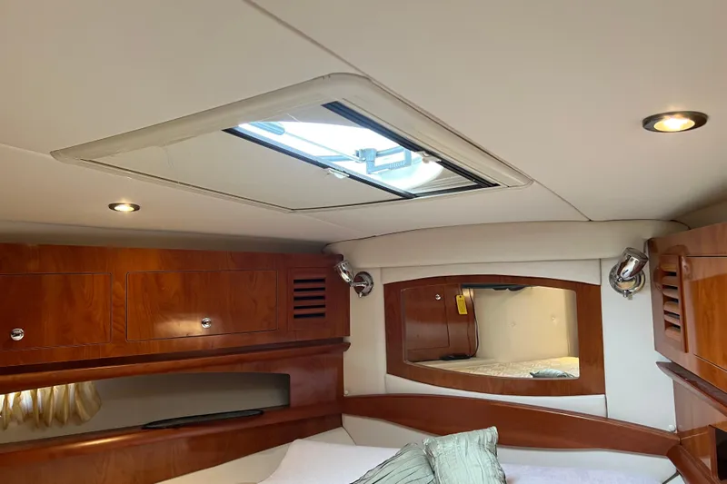 Belle Journee Yacht Photos Pics Interior cabin of 2008 Four Winns V378 yacht with wood finish and skylight.