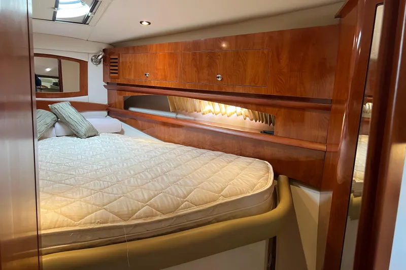 Belle Journee Yacht Photos Pics Luxurious cabin interior of 2008 Four Winns V378 yacht with wood finish and cozy bedding.