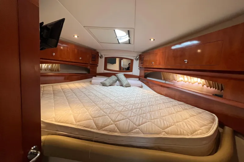Belle Journee Yacht Photos Pics Luxurious cabin interior of 2008 Four Winns V378 yacht with cozy bed and wooden cabinetry.