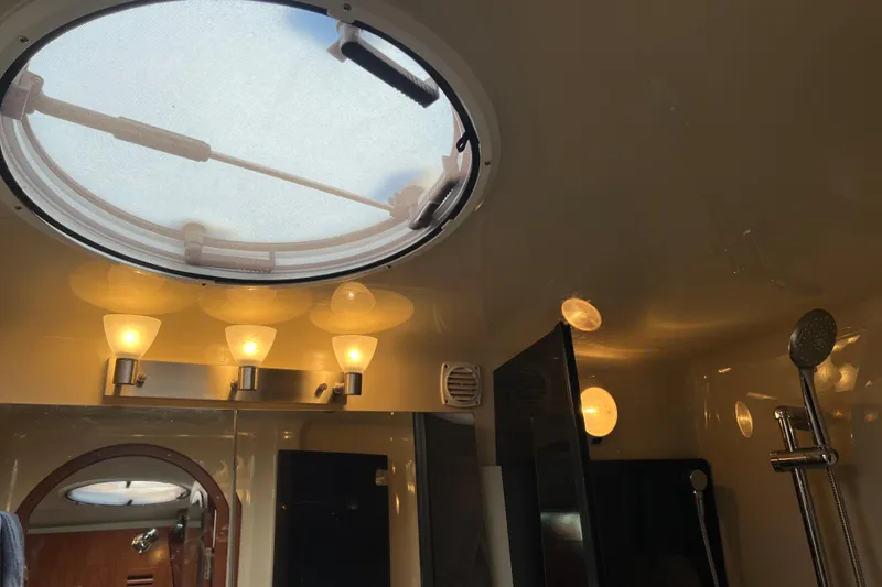 Belle Journee Yacht Photos Pics Interior of 2008 Four Winns V378 yacht bathroom with skylight and modern lighting.