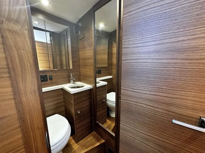 Nirvana Yacht Photos Pics Luxurious bathroom in 2020 Coastal Craft 33 Express yacht with wood paneling and modern fixtures.