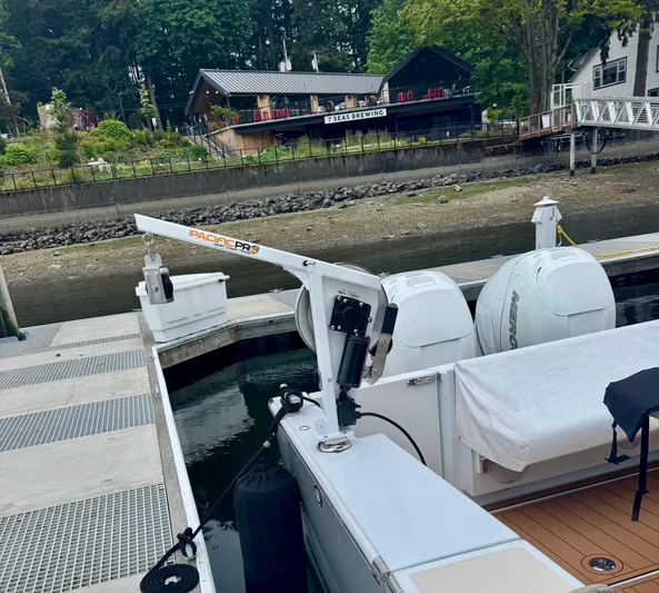 Nirvana Yacht Photos Pics 2020 Coastal Craft 33 Express docked near a scenic waterfront restaurant.