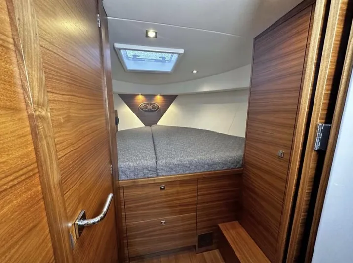 Nirvana Yacht Photos Pics 2020 Coastal Craft 33 Express cabin interior with wood finish and skylight.