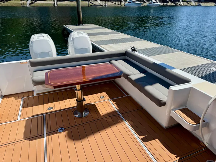 Nirvana Yacht Photos Pics 2020 Coastal Craft 33 Express boat with teak deck and seating area by the dock.