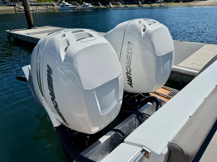 Nirvana Yacht Photos Pics Twin Mercury outboard engines on a 2020 Coastal Craft 33 Express boat at a dock.