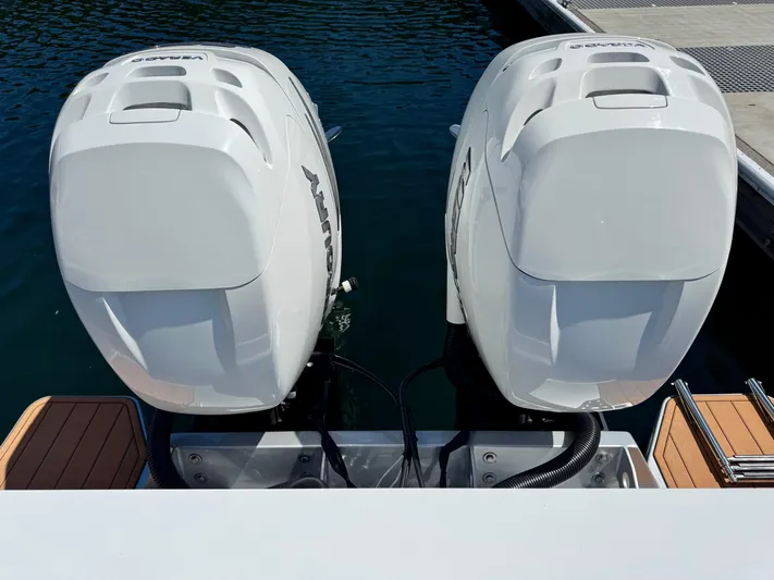 Nirvana Yacht Photos Pics Twin outboard engines on a 2020 Coastal Craft 33 Express boat at a dock.