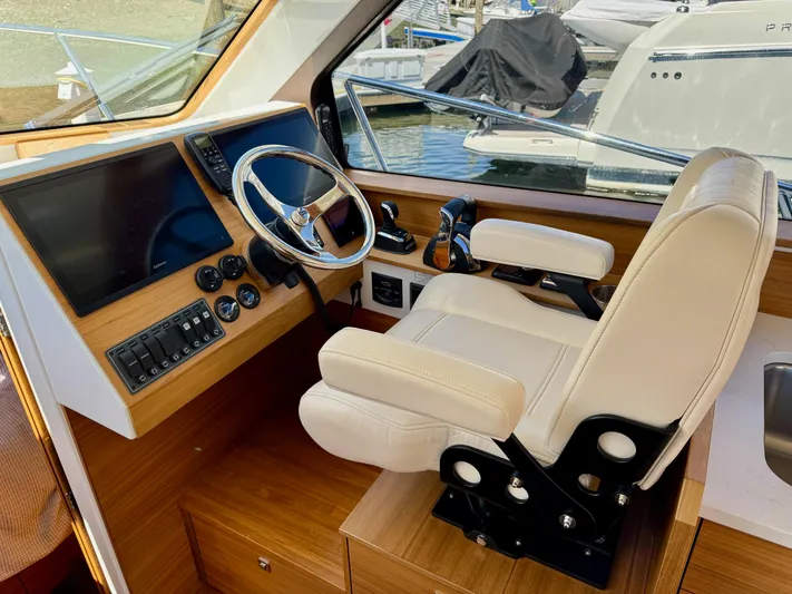 Nirvana Yacht Photos Pics 2020 Coastal Craft 33 Express helm with modern controls and comfortable captain's chair.