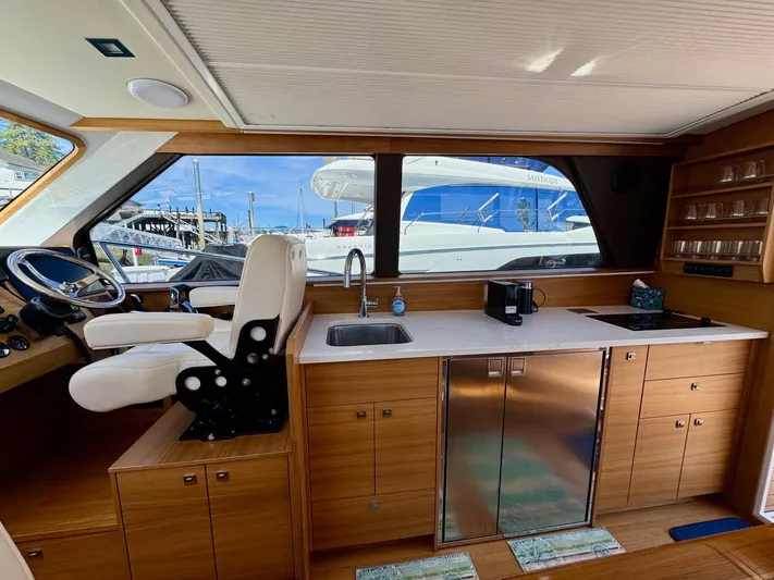 Nirvana Yacht Photos Pics Interior of 2020 Coastal Craft 33 Express yacht with helm, sink, and cabinetry.