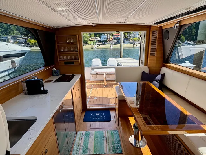 Nirvana Yacht Photos Pics Interior of 2020 Coastal Craft 33 Express yacht with modern kitchen and dining area.
