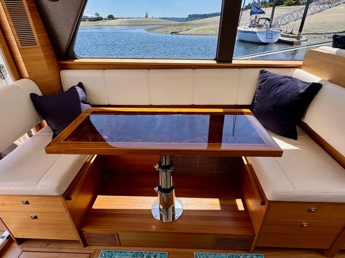 Nirvana Yacht Photos Pics Luxurious interior of 2020 Coastal Craft 33 Express yacht with elegant seating and table.