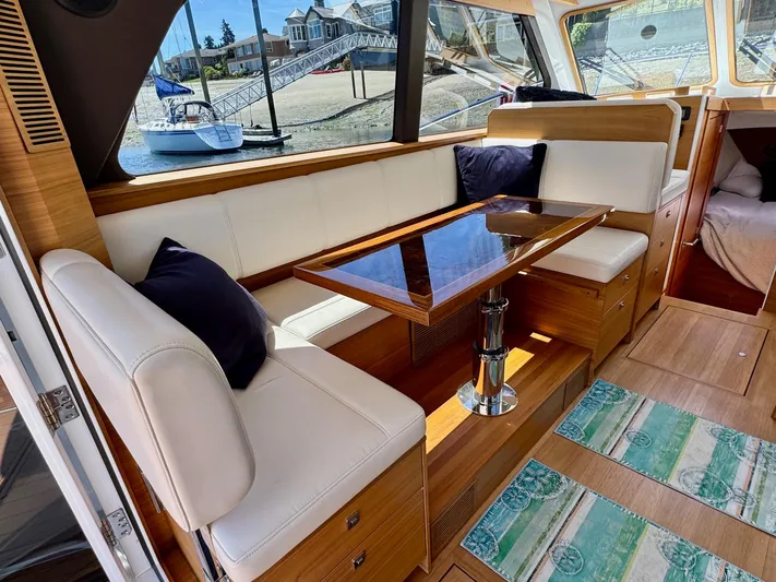 Nirvana Yacht Photos Pics Interior of 2020 Coastal Craft 33 Express yacht with elegant seating and dining area.
