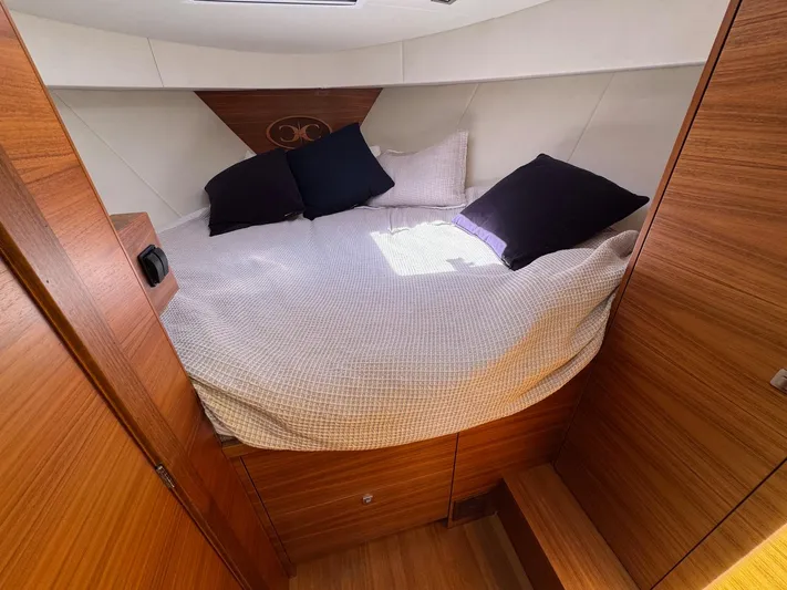 Nirvana Yacht Photos Pics Cozy cabin interior of 2020 Coastal Craft 33 Express with wooden finish and comfortable bedding.