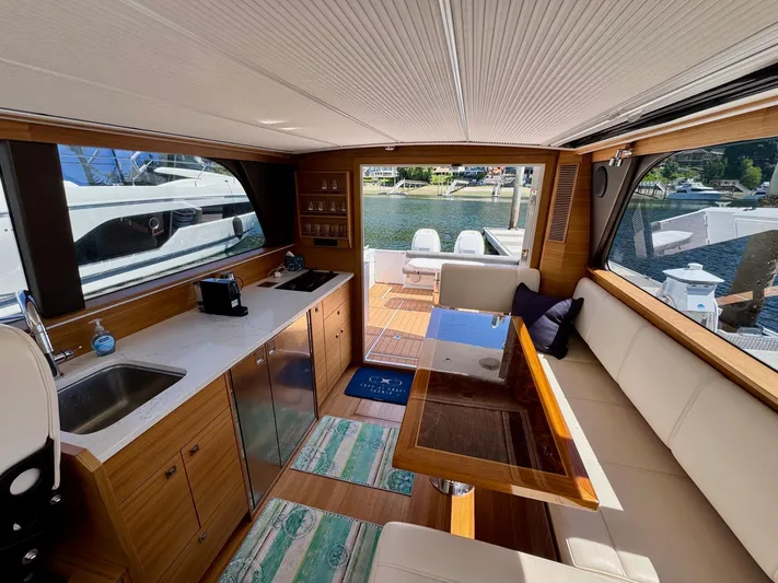 Nirvana Yacht Photos Pics Interior of 2020 Coastal Craft 33 Express yacht with modern kitchen and seating area.