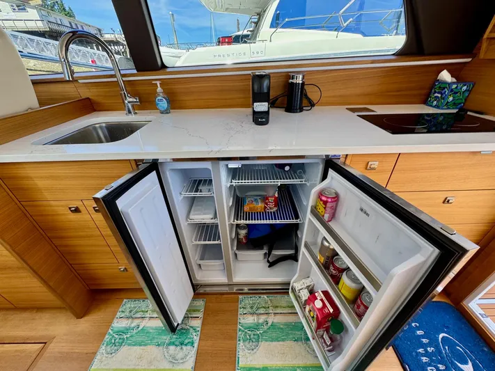Nirvana Yacht Photos Pics Modern kitchen in 2020 Coastal Craft 33 Express yacht with open fridge and sleek countertops.