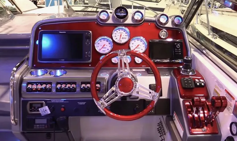  Yacht Photos Pics Control panel of a 2015 Formula 400 FX8 boat with red steering wheel and gauges.