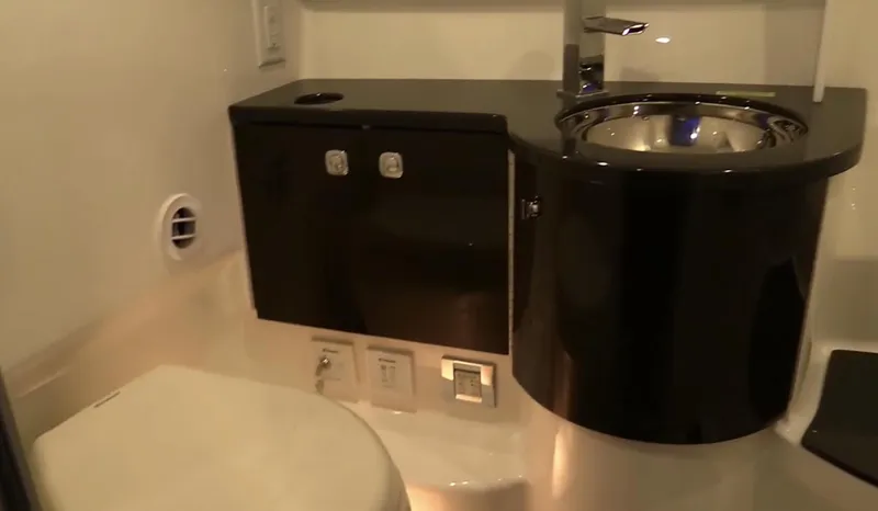  Yacht Photos Pics Modern bathroom in a 2015 Formula 400 FX8 boat with sleek black cabinetry.