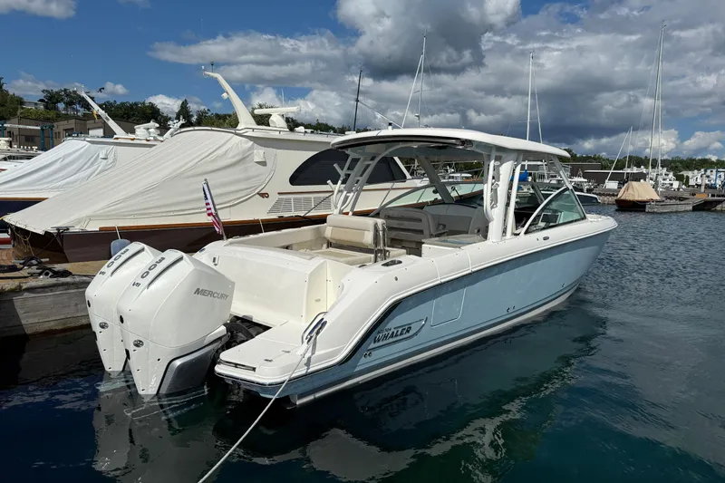  Yacht Photos Pics 2022 Boston Whaler 320 Vantage boat docked with twin Mercury engines.