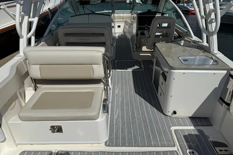  Yacht Photos Pics 2022 Boston Whaler 320 Vantage interior with seating and kitchenette, featuring modern design.