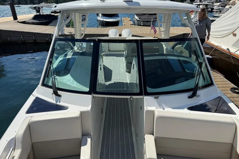  Yacht Photos Pics 2022 Boston Whaler 320 Vantage docked, showcasing sleek design and spacious seating.