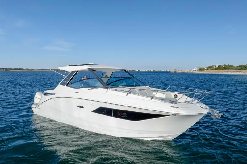  Yacht Photos Pics 2020 Sea Ray Sundancer 320 Outboard cruising on open water under clear blue sky.