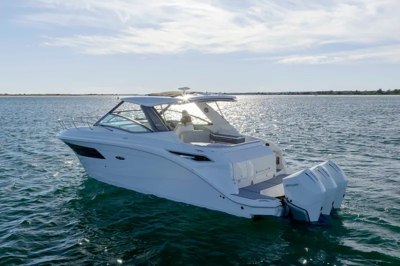  Yacht Photos Pics 2020 Sea Ray Sundancer 320 Outboard cruising on open water under a clear sky.