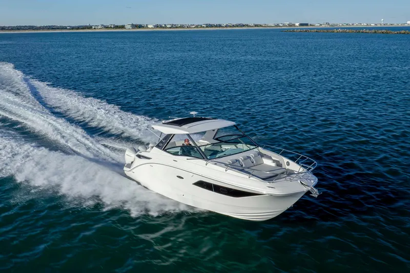  Yacht Photos Pics 2020 Sea Ray Sundancer 320 Outboard cruising on open water, showcasing sleek design and performance.