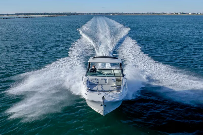  Yacht Photos Pics 2020 Sea Ray Sundancer 320 Outboard cruising on open water, leaving a wake trail.
