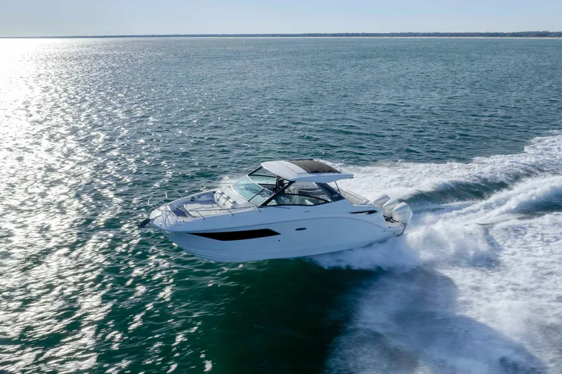  Yacht Photos Pics 2020 Sea Ray Sundancer 320 Outboard cruising on open water, creating a wake.