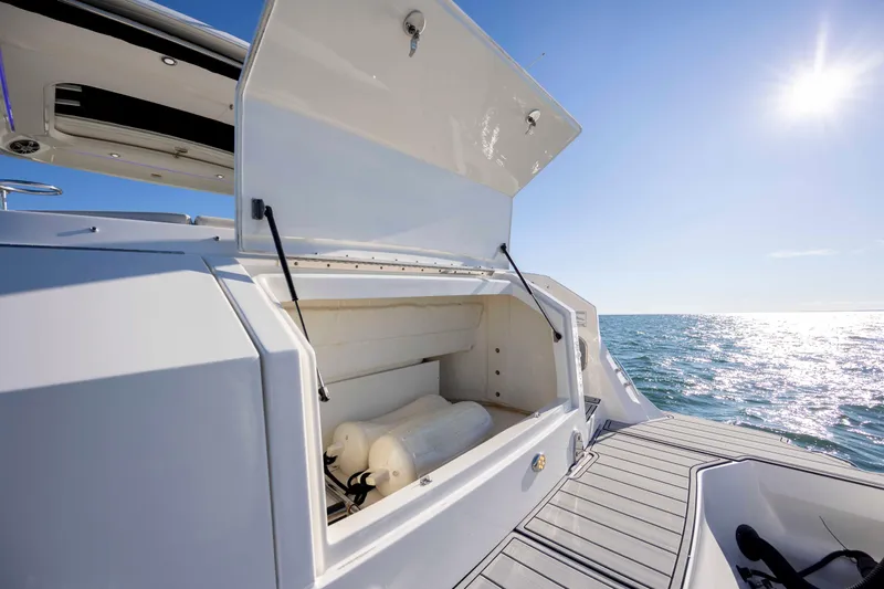  Yacht Photos Pics 2020 Sea Ray Sundancer 320 Outboard storage compartment open on sunny ocean day.