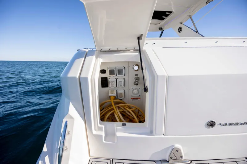  Yacht Photos Pics 2020 Sea Ray Sundancer 320 Outboard with open electrical panel, ocean backdrop.