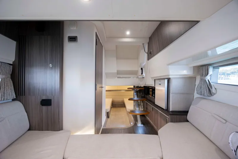  Yacht Photos Pics Interior of 2020 Sea Ray Sundancer 320 Outboard, featuring modern seating and kitchenette.