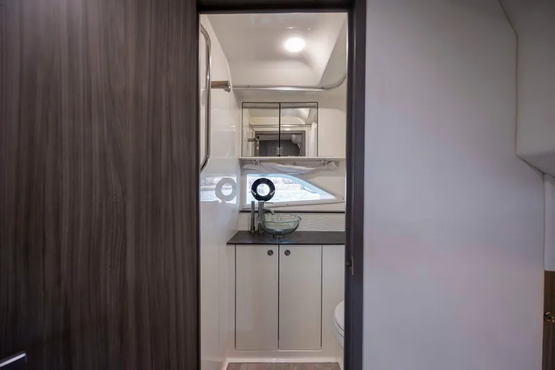  Yacht Photos Pics 2020 Sea Ray Sundancer 320 Outboard bathroom interior with modern fixtures and wood accents.