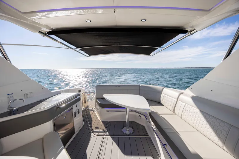  Yacht Photos Pics 2020 Sea Ray Sundancer 320 Outboard interior with ocean view, featuring seating and table.