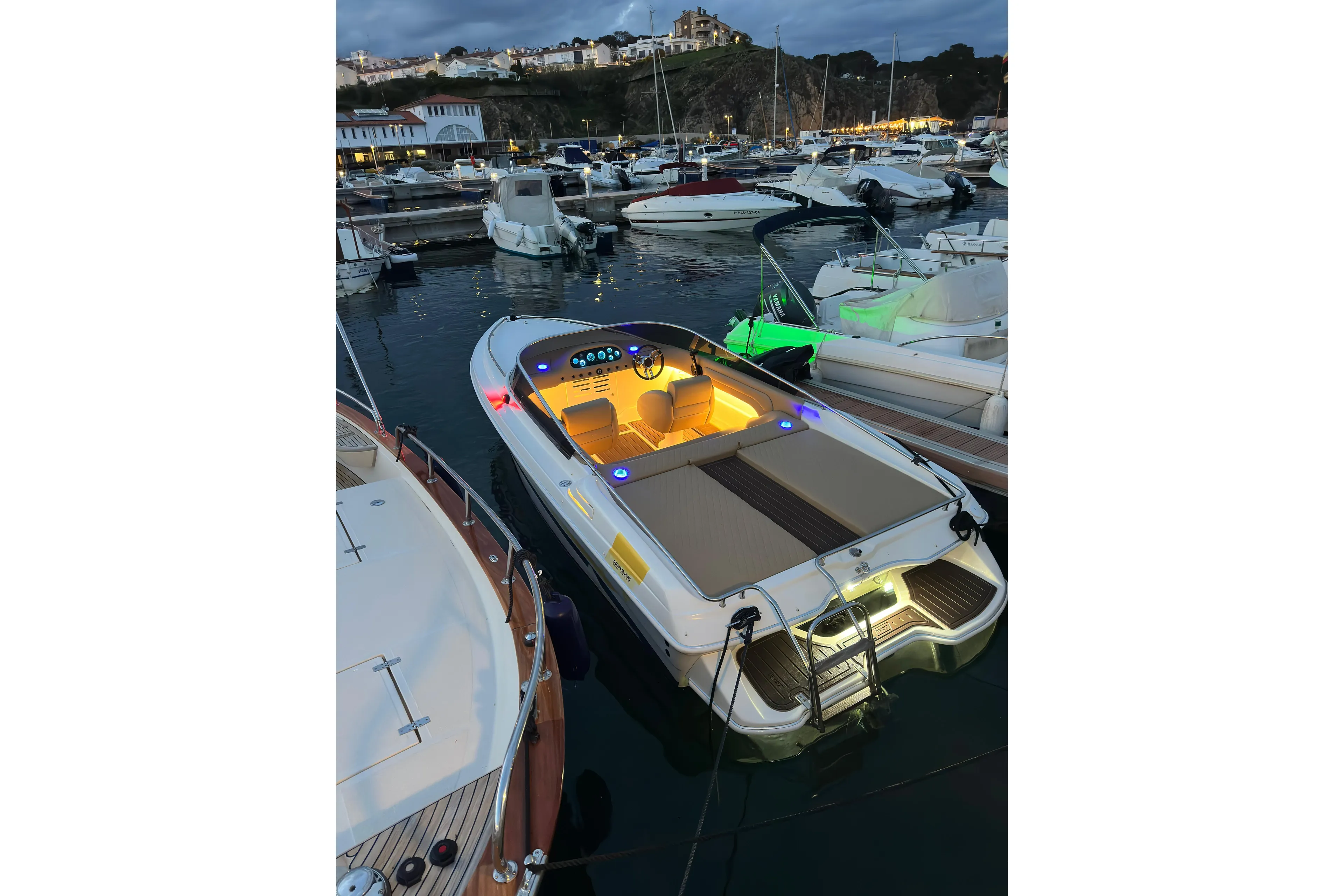 Luxurious 2000 Performance 607 boat docked at marina during evening.