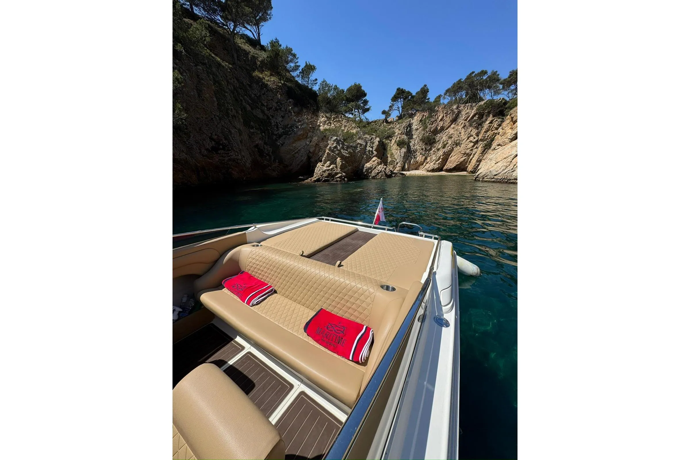 Boat in scenic cove with rocky cliffs, Performance 607, 2000 model.