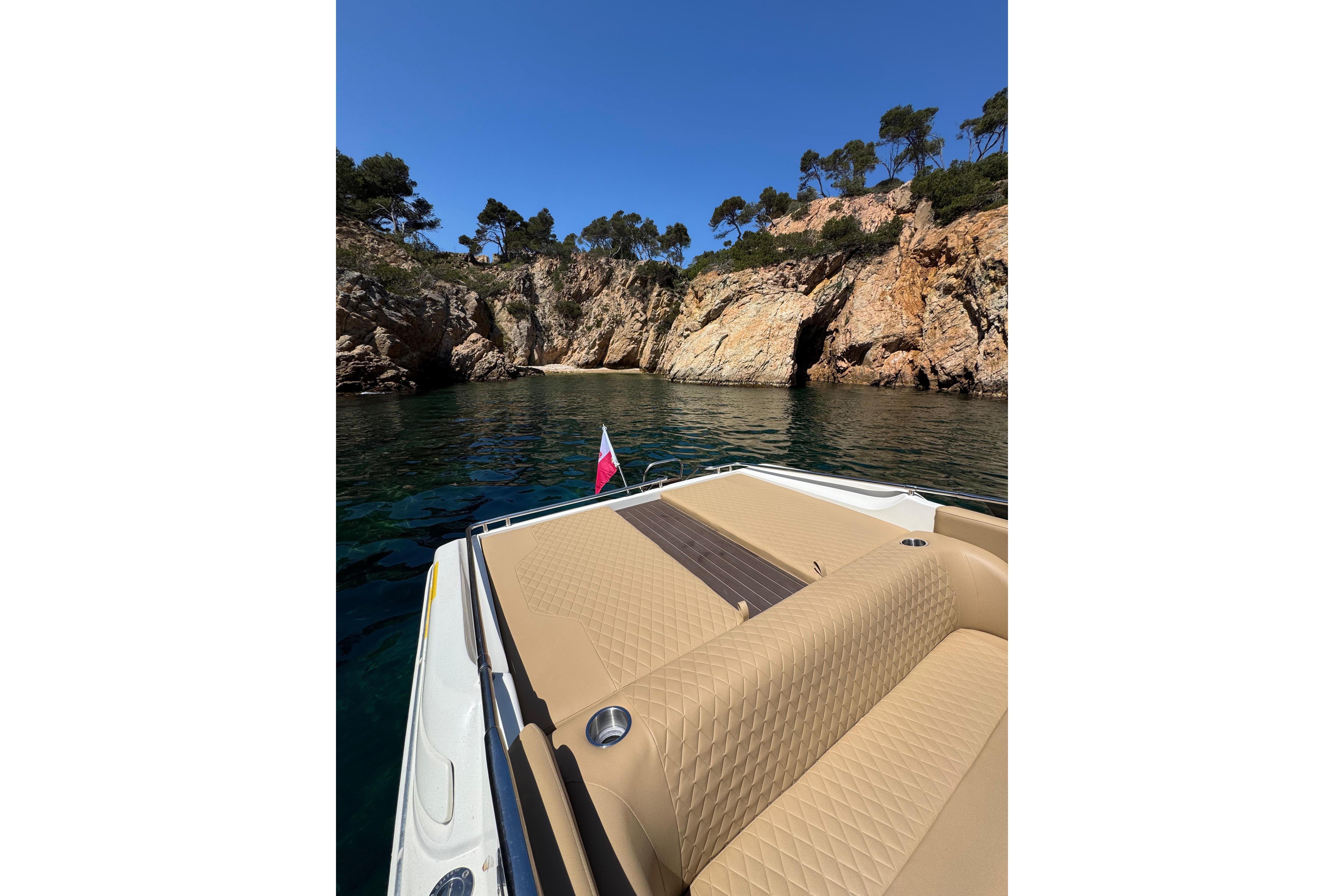 Luxury Performance 607 boat cruising near rocky cliffs, 2000 model.