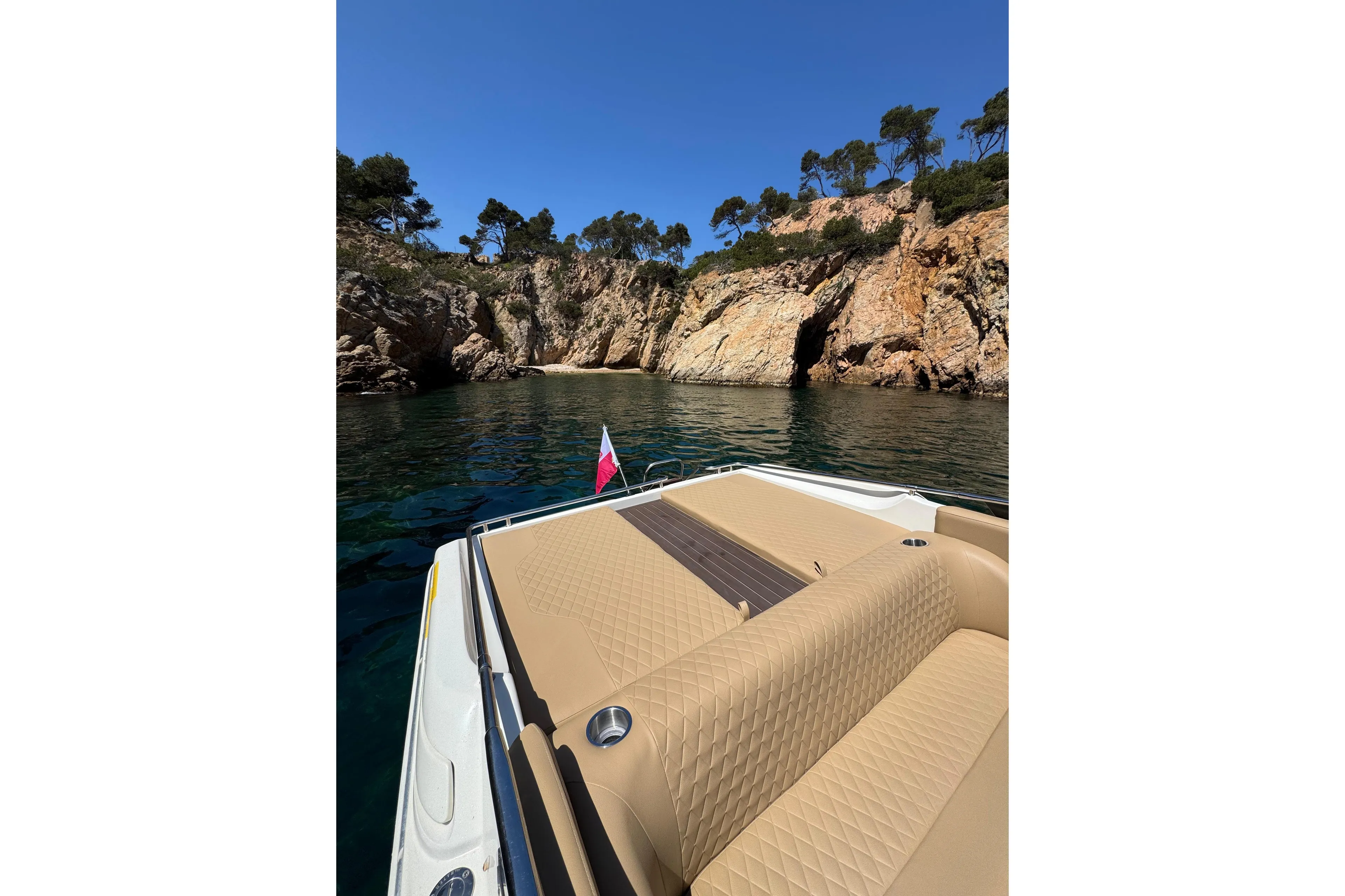 Luxury Performance 607 boat cruising near rocky cliffs, 2000 model.