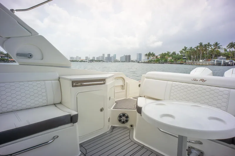 Yacht Photos Pics 2022 Sea Ray SDX 290 Outboard interior with seating, table, and waterfront view.