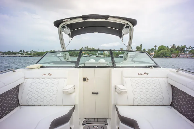  Yacht Photos Pics 2022 Sea Ray SDX 290 Outboard boat interior with white seating and canopy on a calm lake.