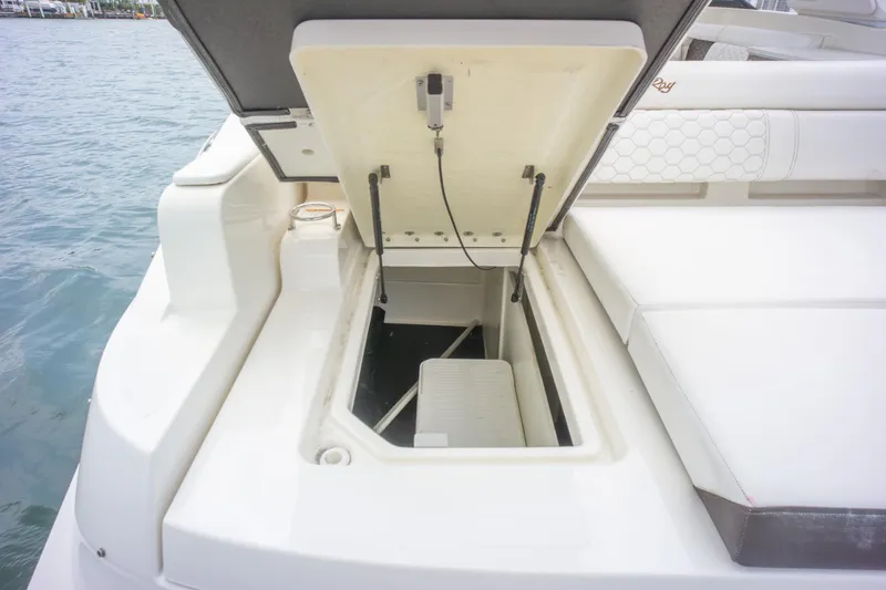  Yacht Photos Pics 2022 Sea Ray SDX 290 Outboard boat storage compartment open by the water.